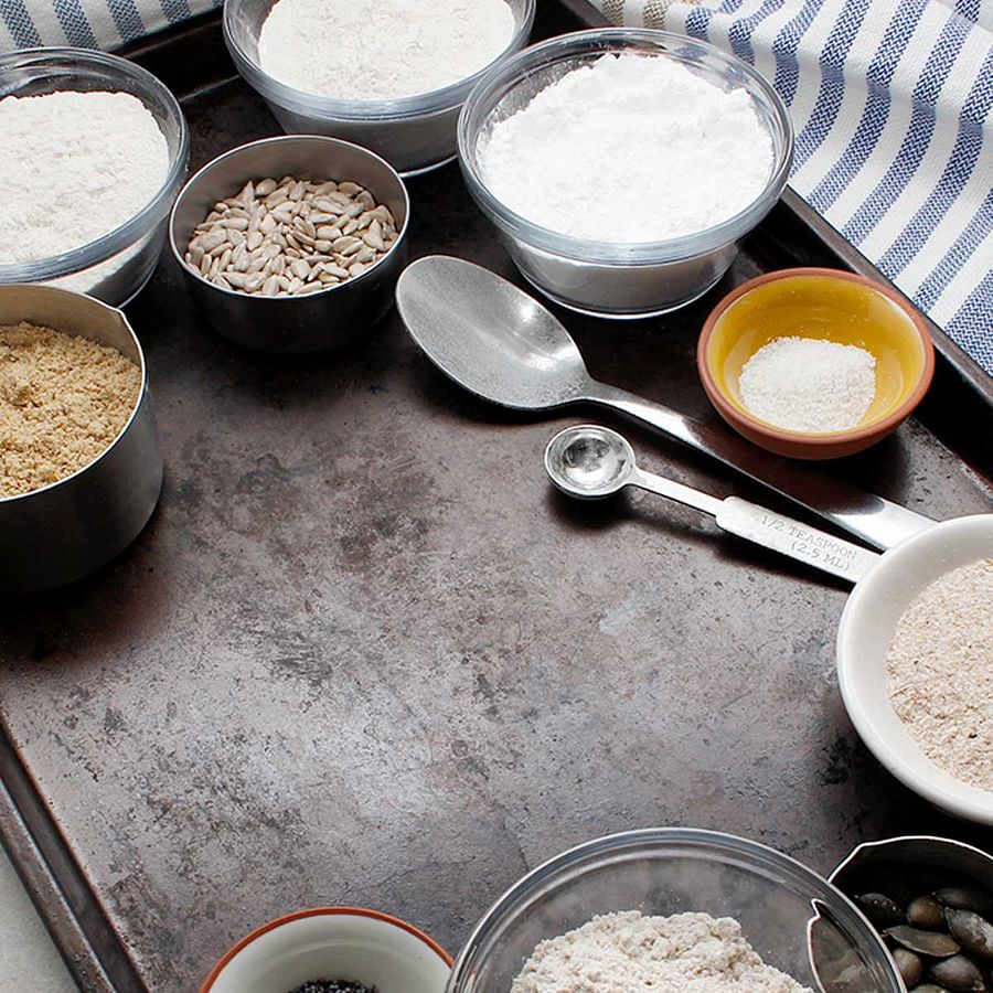 Assortment of vegan baking ingredients including almond milk, flaxseed, and vegan chocolate